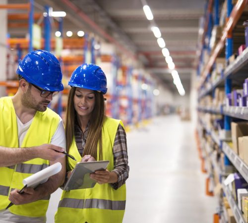 warehouse-workers-checking-inventory-consulting-each-other-about-organization-distribution-goods-min